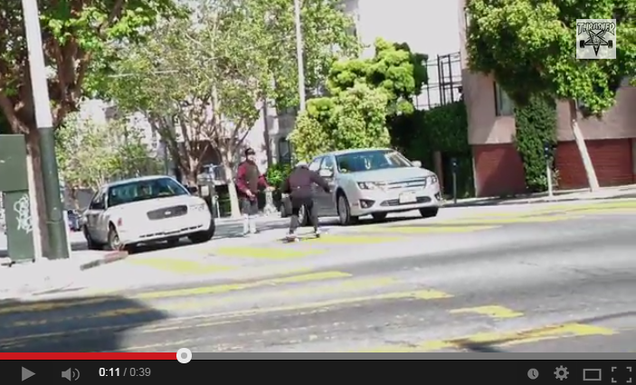 Dude gets hit by a car while skateboarding because his 'spotter' friend failed.